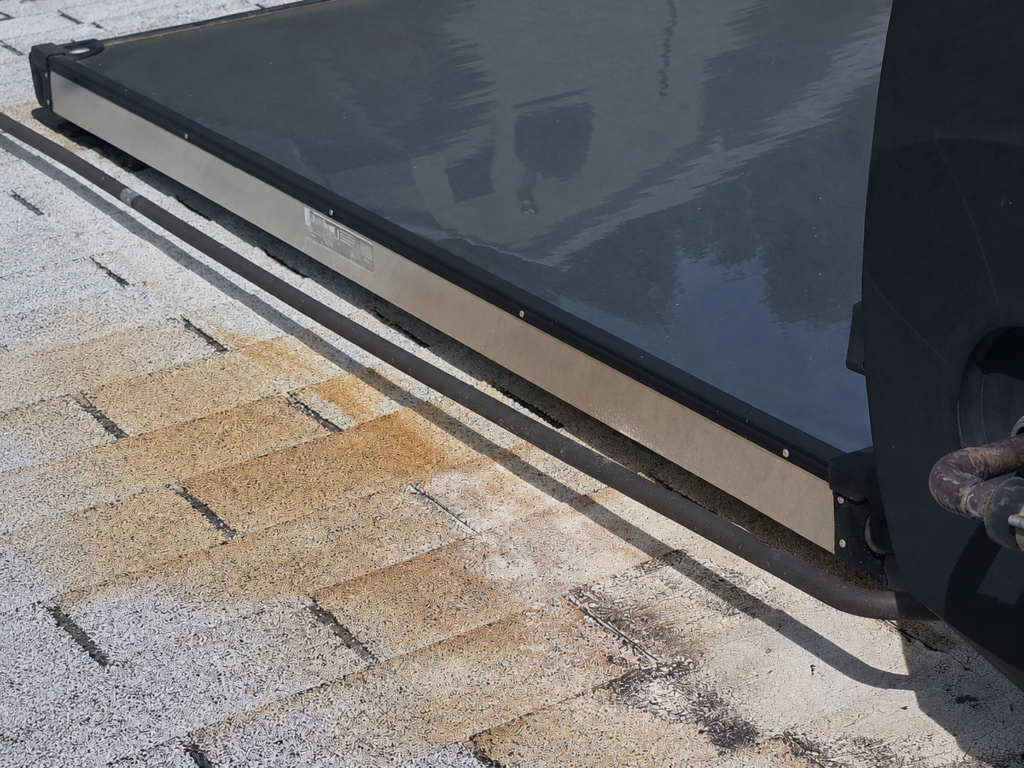 Solar Water Heater Roof Damage – Sacramento Roof shingle damage around a solar water heating system on a Sacramento home